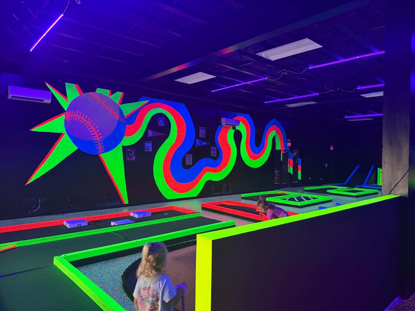 Baseball neon mural inside Grand Slam Glow Golf Branson