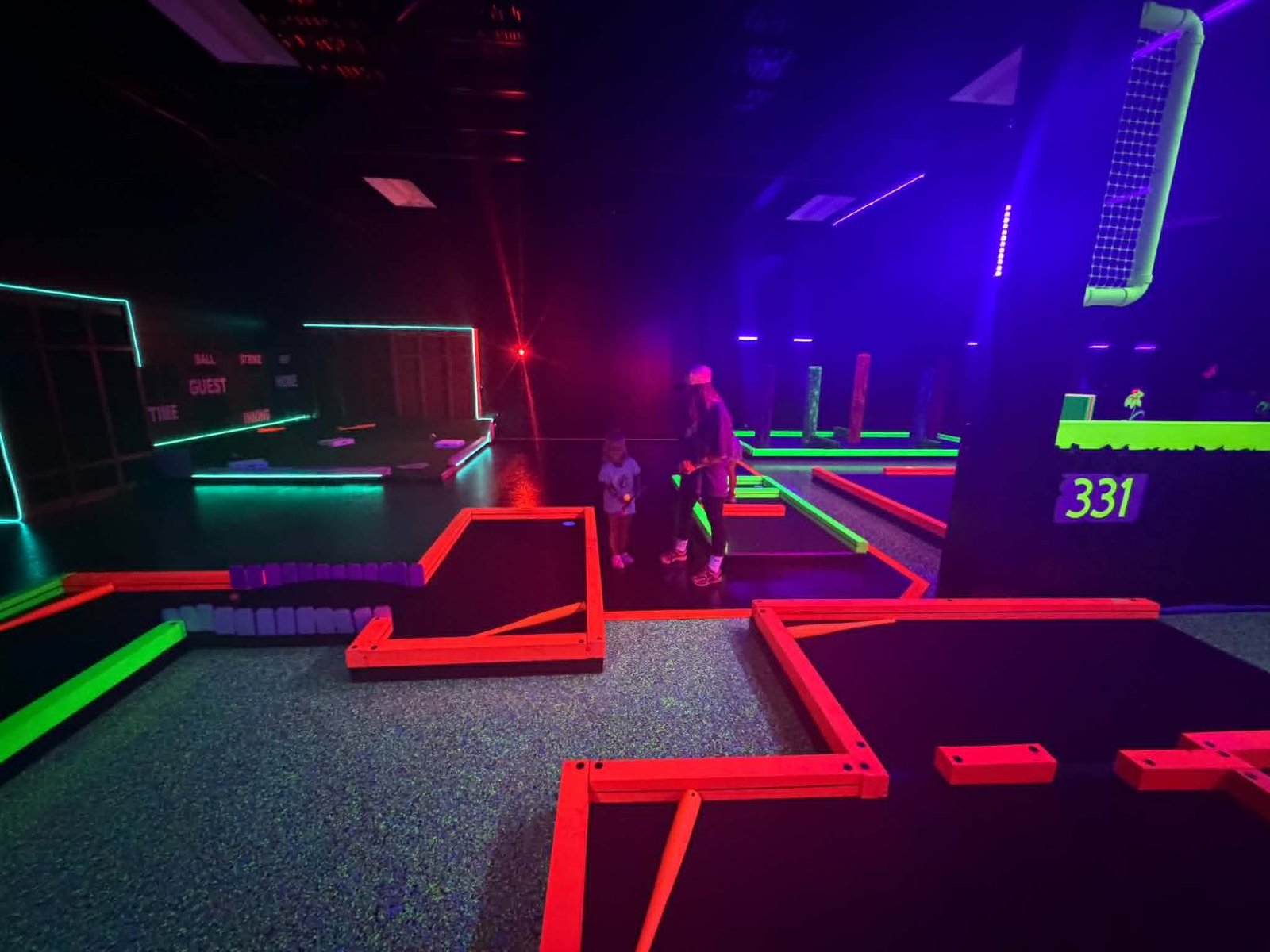 Family playing glow mini golf at Grand Slam Entertainment Branson