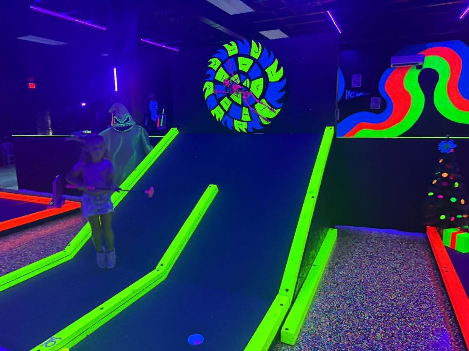 Kids playing blacklight mini golf Grand Slam Branson MO
